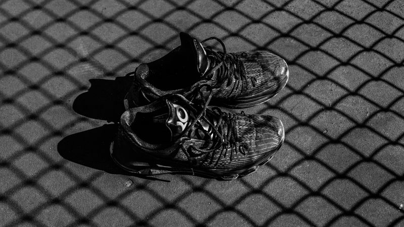 Black Basketball Shoes on a Grey Court
